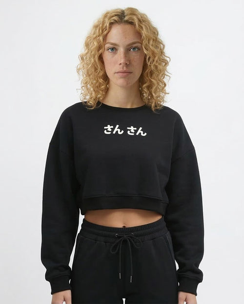 Person wearing a black sweatshirt with white text on a plain background