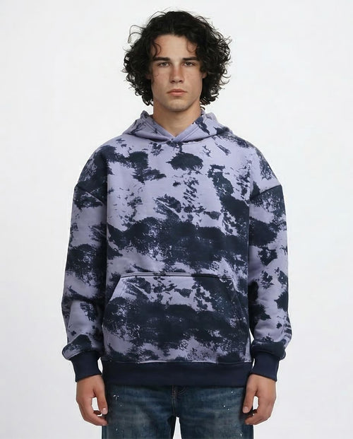 Person wearing a camouflage hoodie on a white background