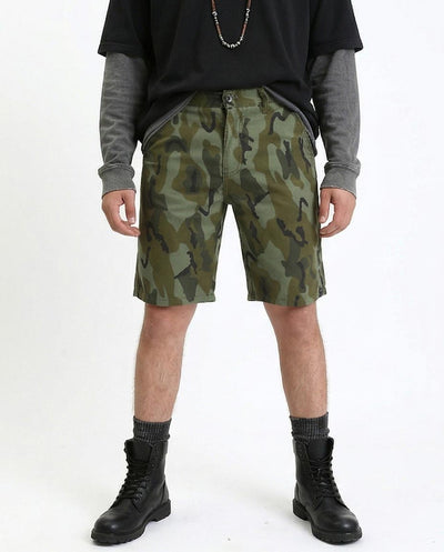 Person wearing camouflage shorts on a white background