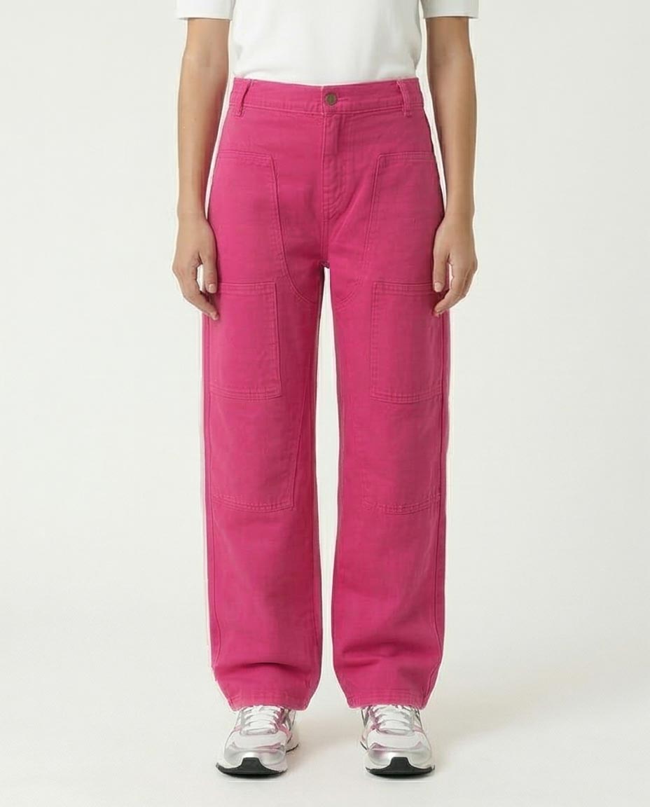 Woman wearing bright pink pants on a white background