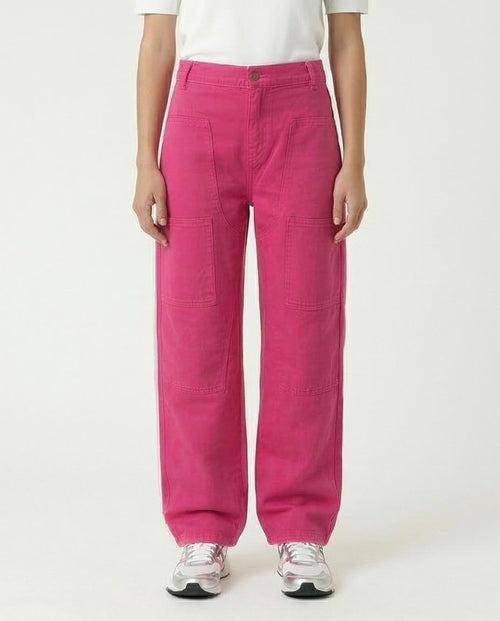 Woman wearing bright pink pants on a white background