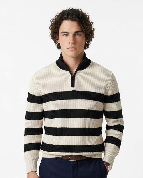 Man wearing a black and white striped sweater on a white background