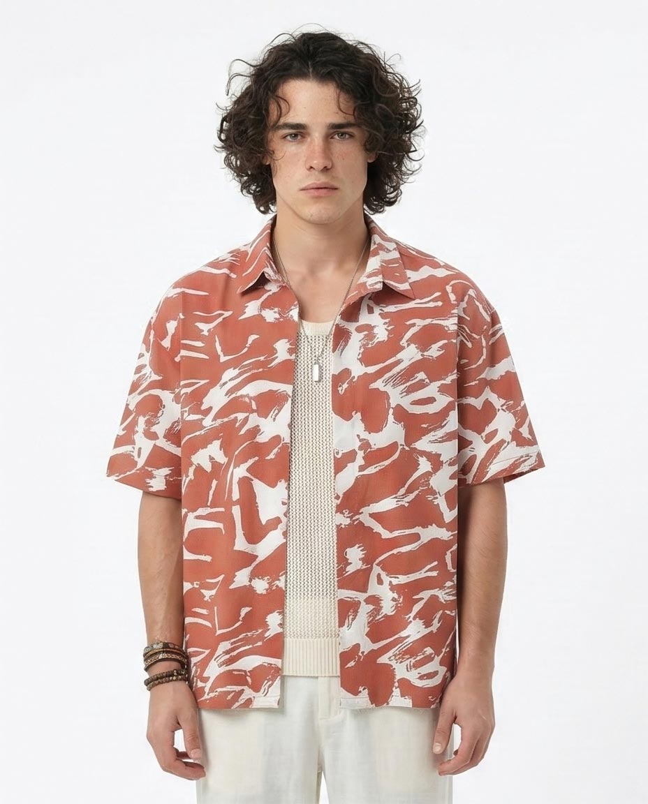 Man wearing a patterned shirt with a white background