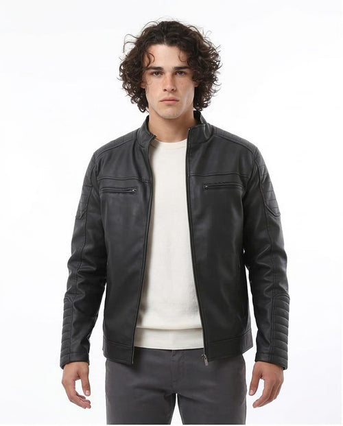 Man wearing a dark gray leather jacket over a white shirt on a white background