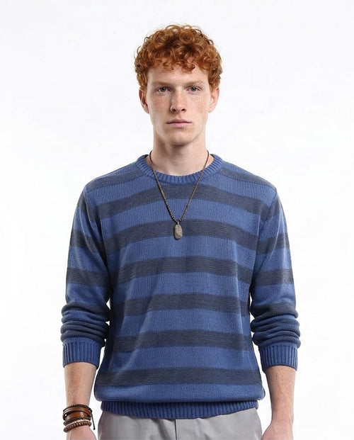 Man wearing a blue and gray striped sweater on a white background