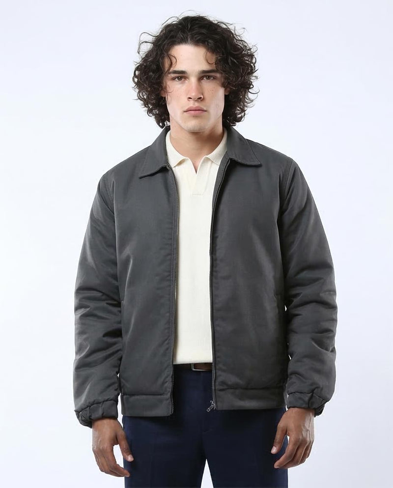 Man wearing a gray jacket over a white shirt on a white background