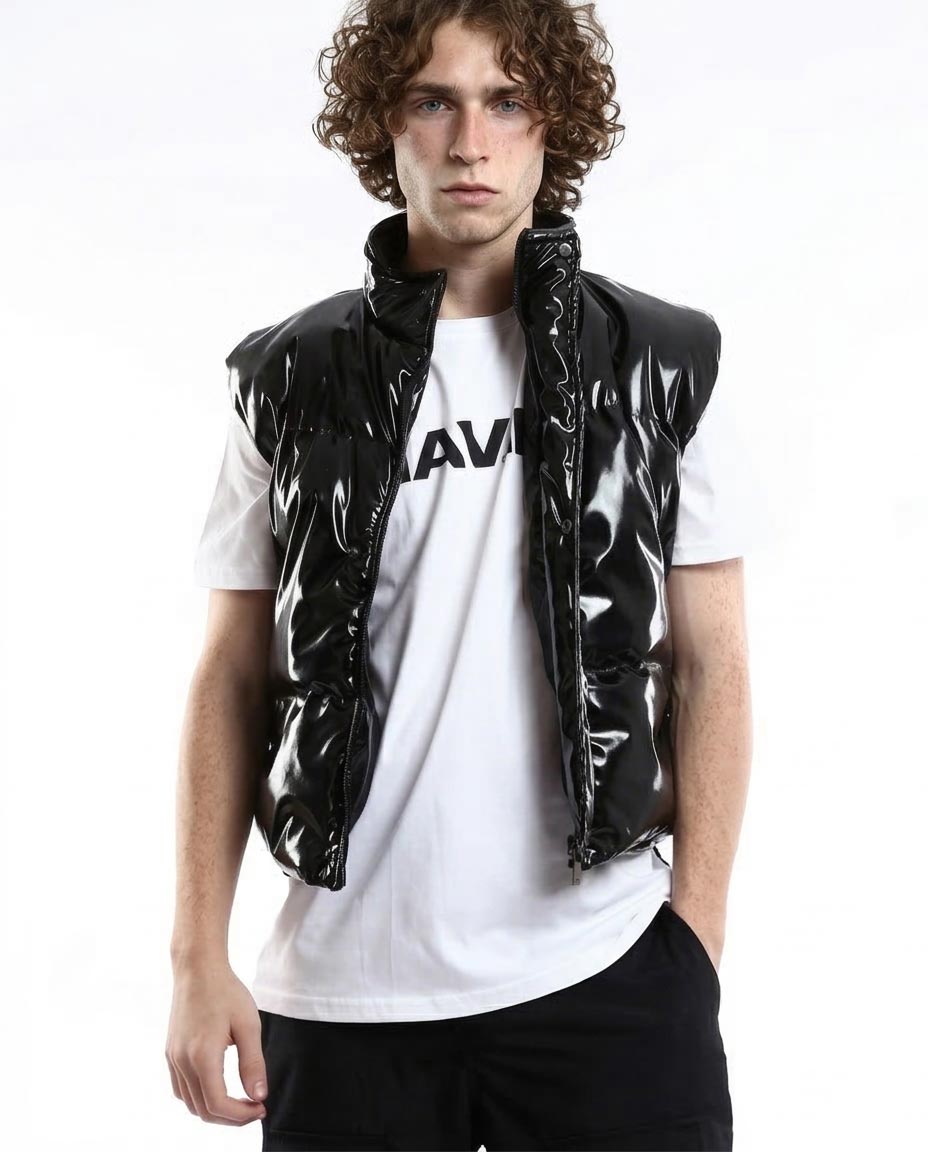 Person wearing a black vinyl vest over a white t-shirt with a logo on a white background