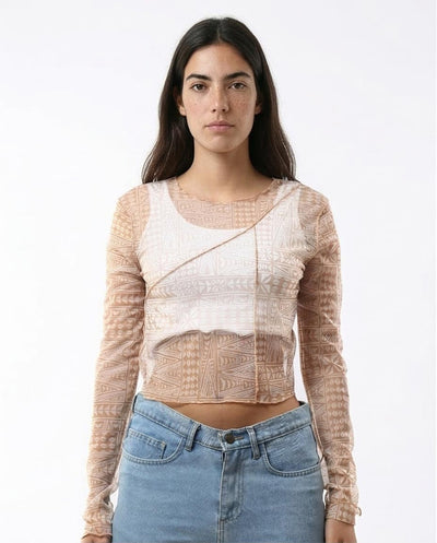 Woman wearing a sheer long-sleeve top with a white background