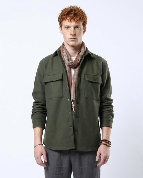 Man wearing a green shirt with a scarf on a white background