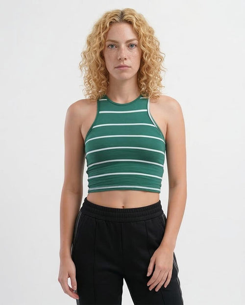 Woman wearing a green and white striped tank top against a white background