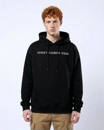 Person wearing a black hoodie with 'Street Fashion Wear' text on a white background