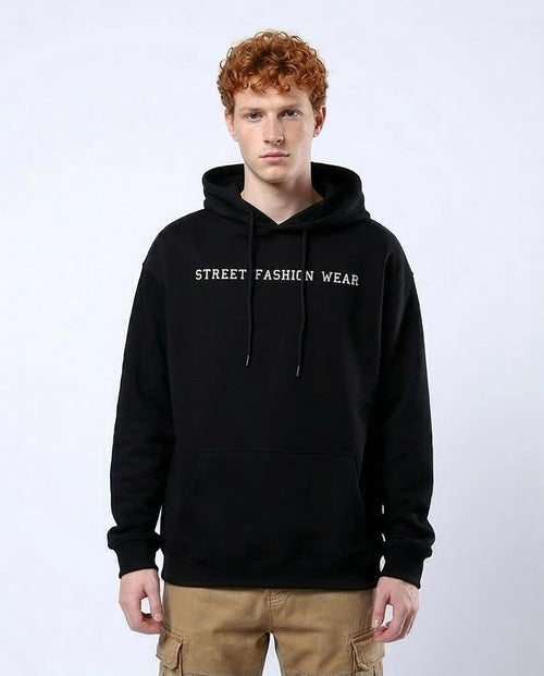 Person wearing a black hoodie with 'Street Fashion Wear' text on a white background