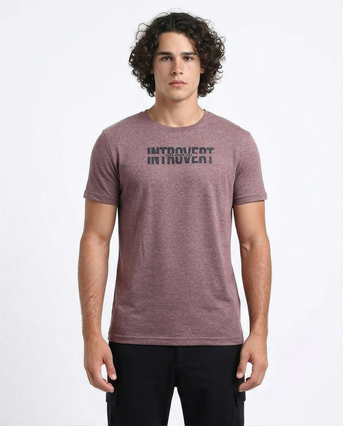Man wearing a maroon t-shirt with 'INTROVERT' text on a white background