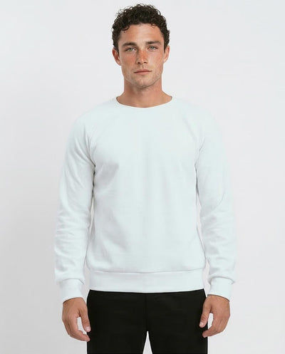 Man wearing a light blue sweatshirt against a white background