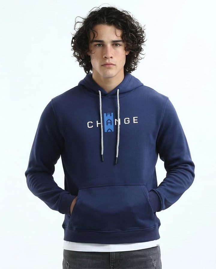 Man wearing a blue hoodie with 'Change' text on a white background