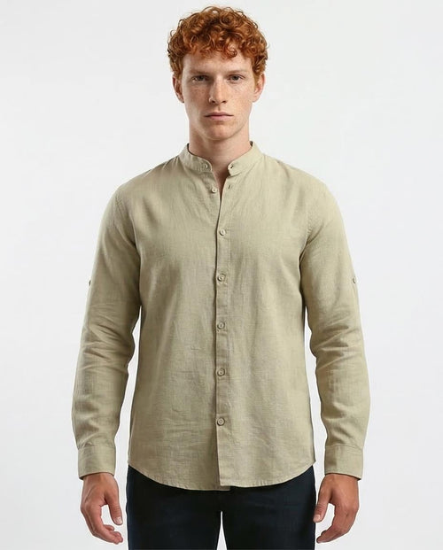 Man wearing a beige long-sleeve shirt on a white background