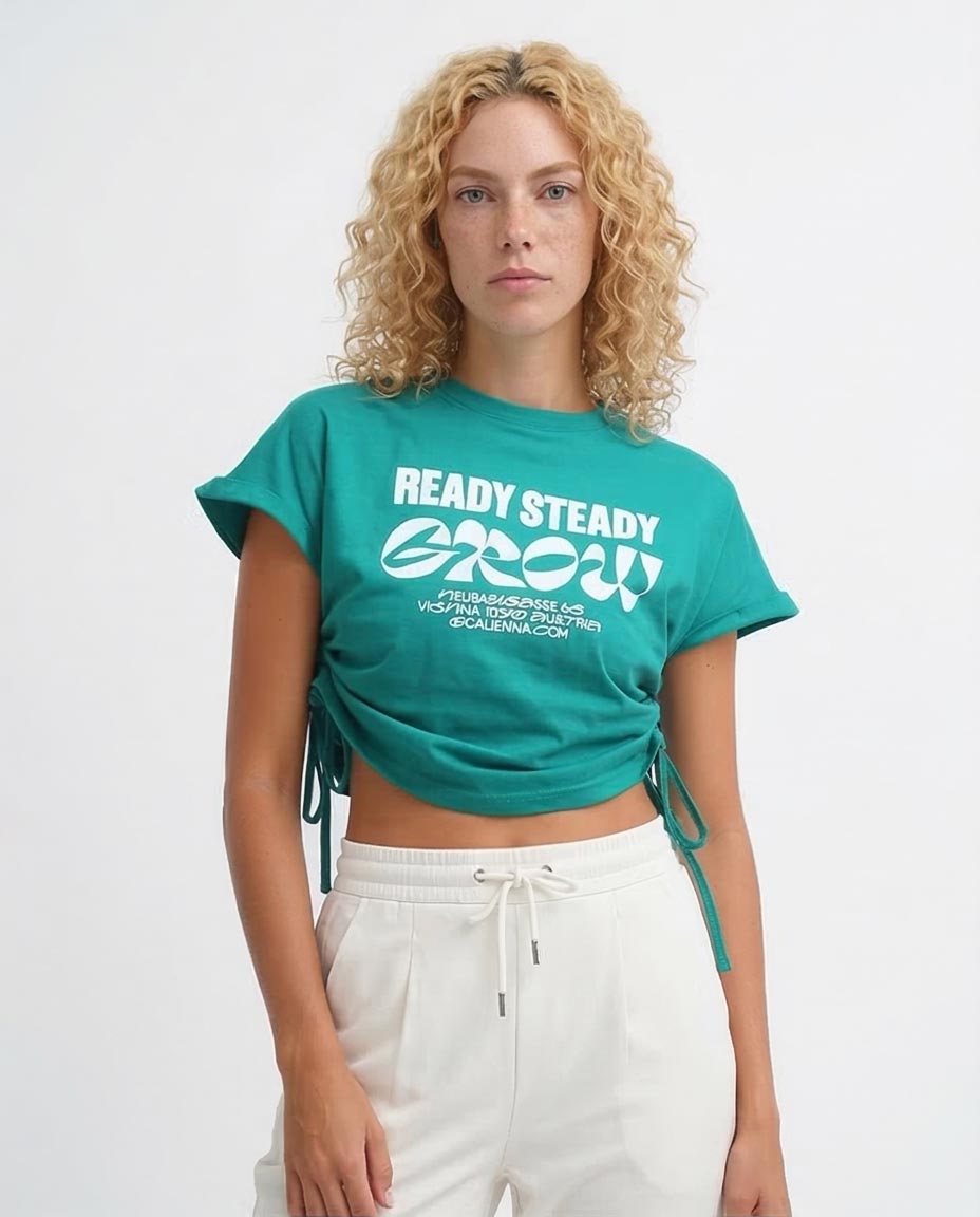 Person wearing a teal t-shirt with 'READY STEADY GROW!' text on a white background