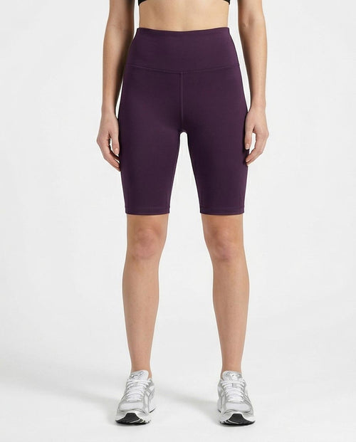 woman wearing purple athletic shorts on a white background