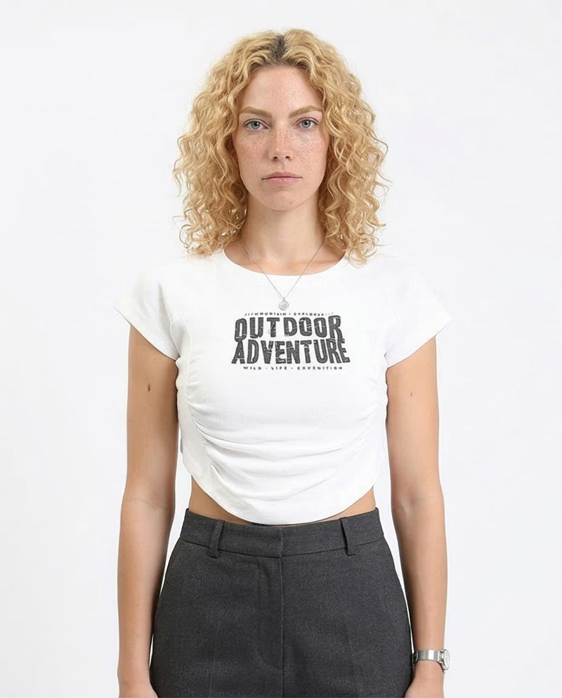 Person wearing a white t-shirt with 'Outdoor Adventure' text on a plain background