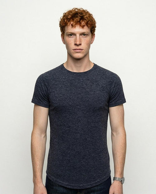 Man wearing a dark blue t-shirt against a plain background