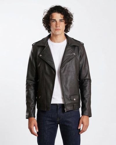 Man wearing a black leather jacket over a white shirt on a white background