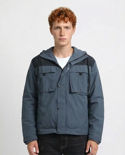 Person wearing a blue hooded jacket on a white background