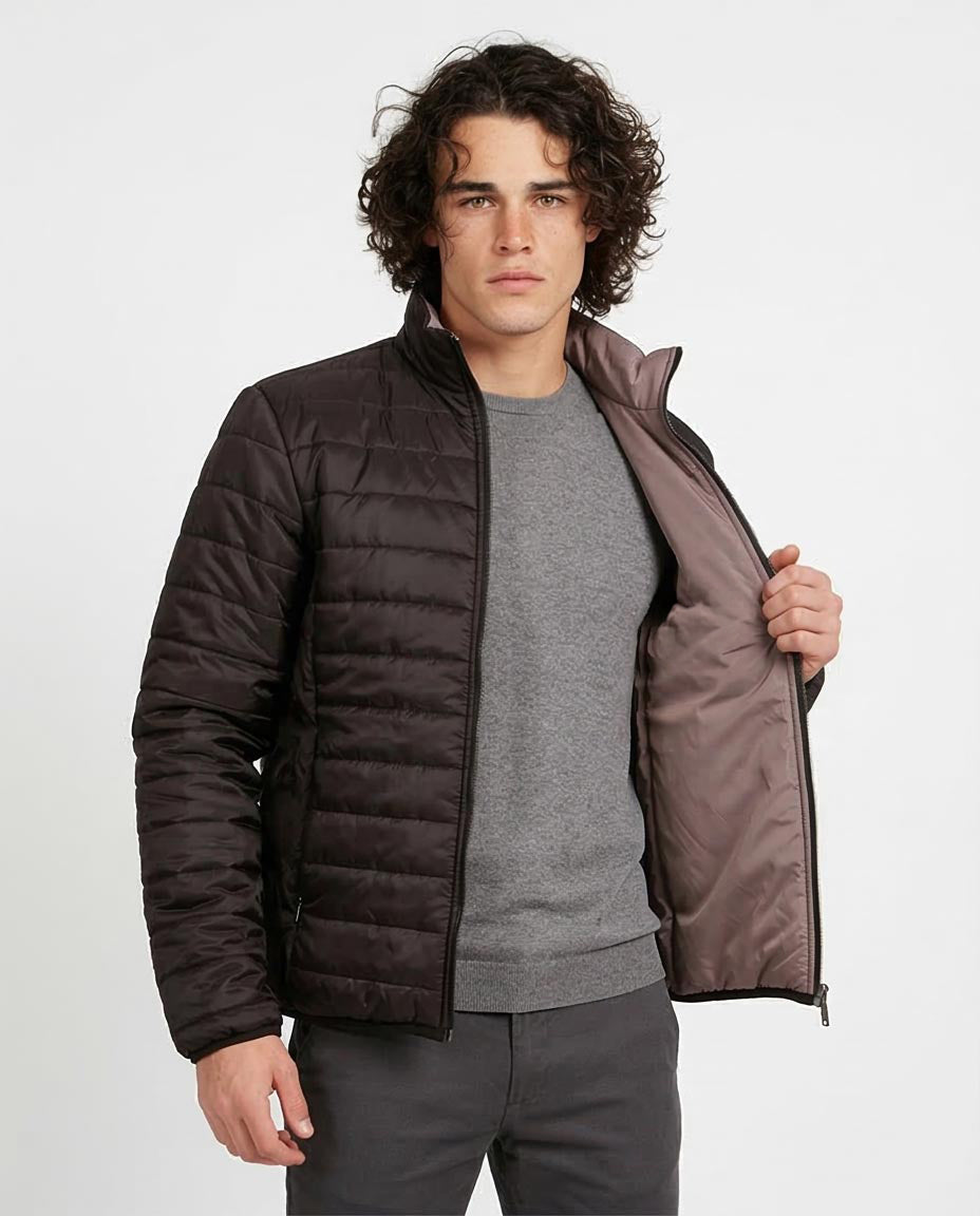 Man wearing a dark brown quilted jacket on a white background