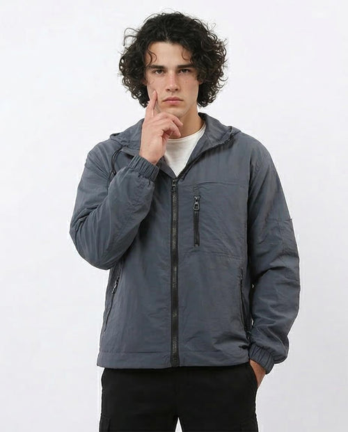 Man wearing a gray jacket on a white background