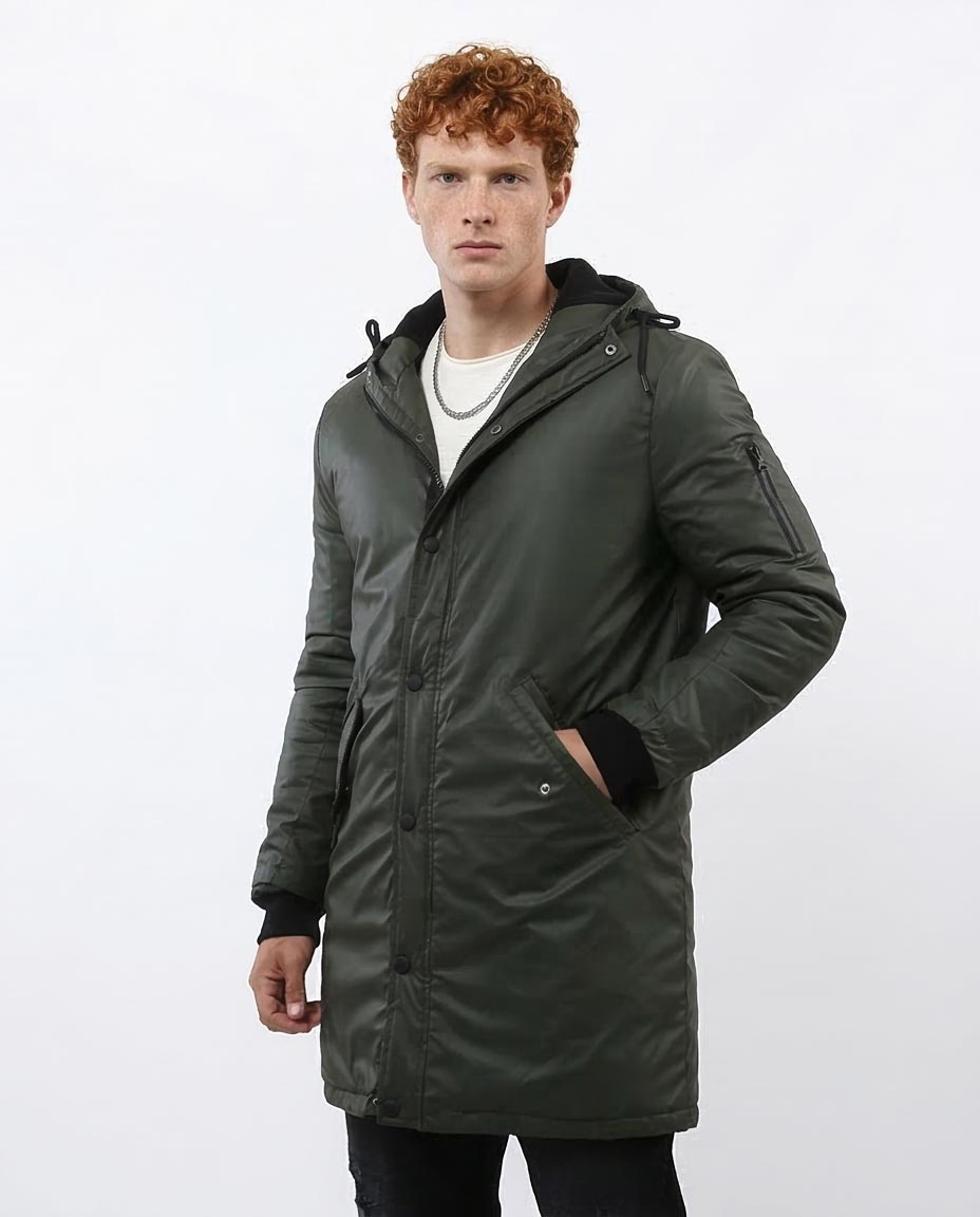 Man wearing a green parka coat on a white background
