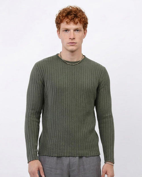Man wearing a green ribbed sweater on a white background
