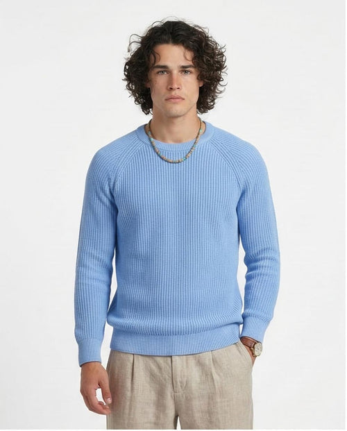 Man wearing a light blue sweater on a white background