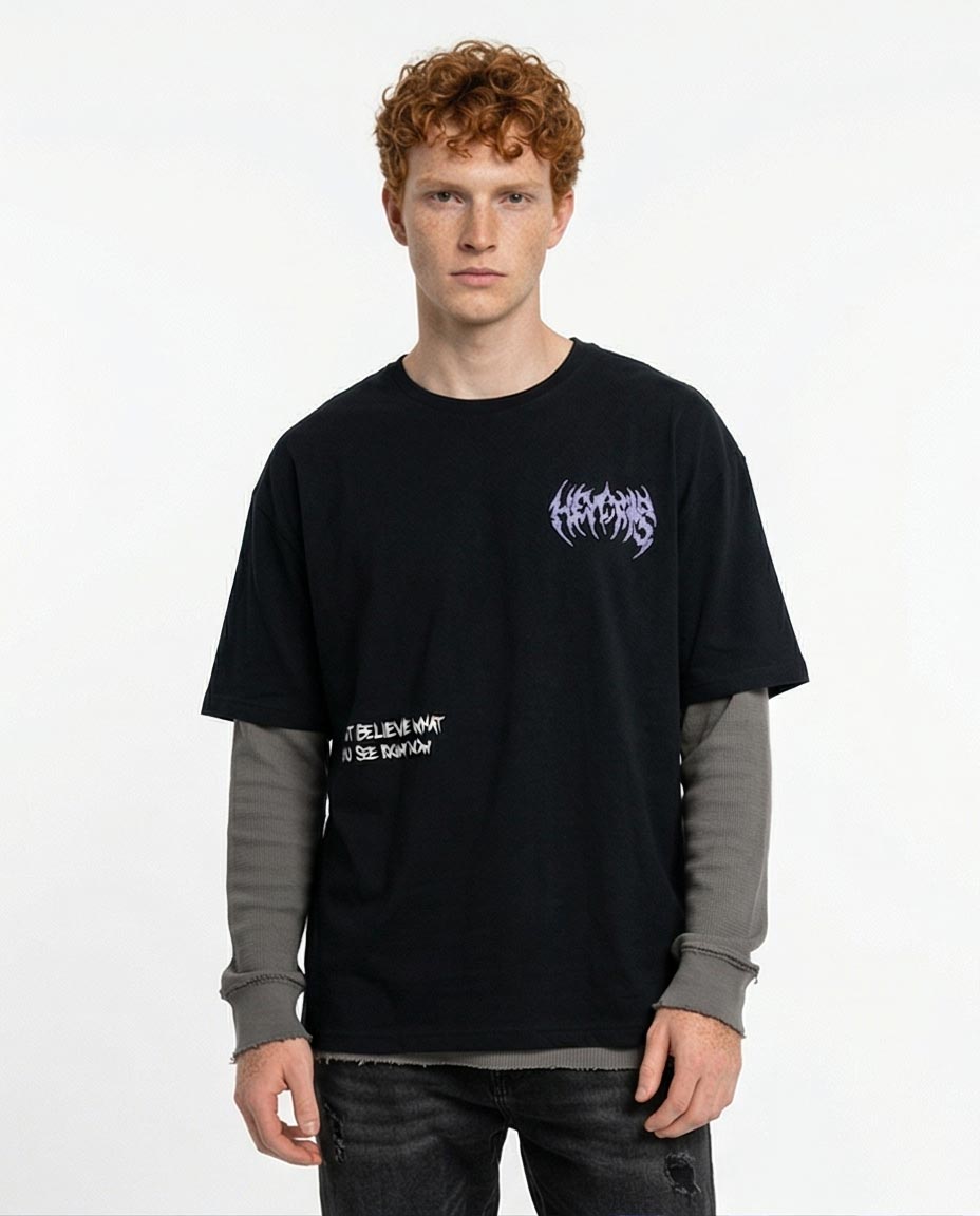 Person wearing a black t-shirt with text and graphics on a white background