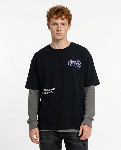 Person wearing a black t-shirt with text and graphics on a white background