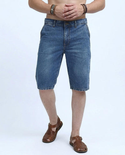 Person wearing blue denim shorts on a white background