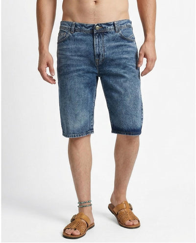Man wearing blue denim shorts on a white background