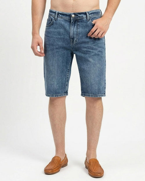 man wearing blue denim shorts on a white background