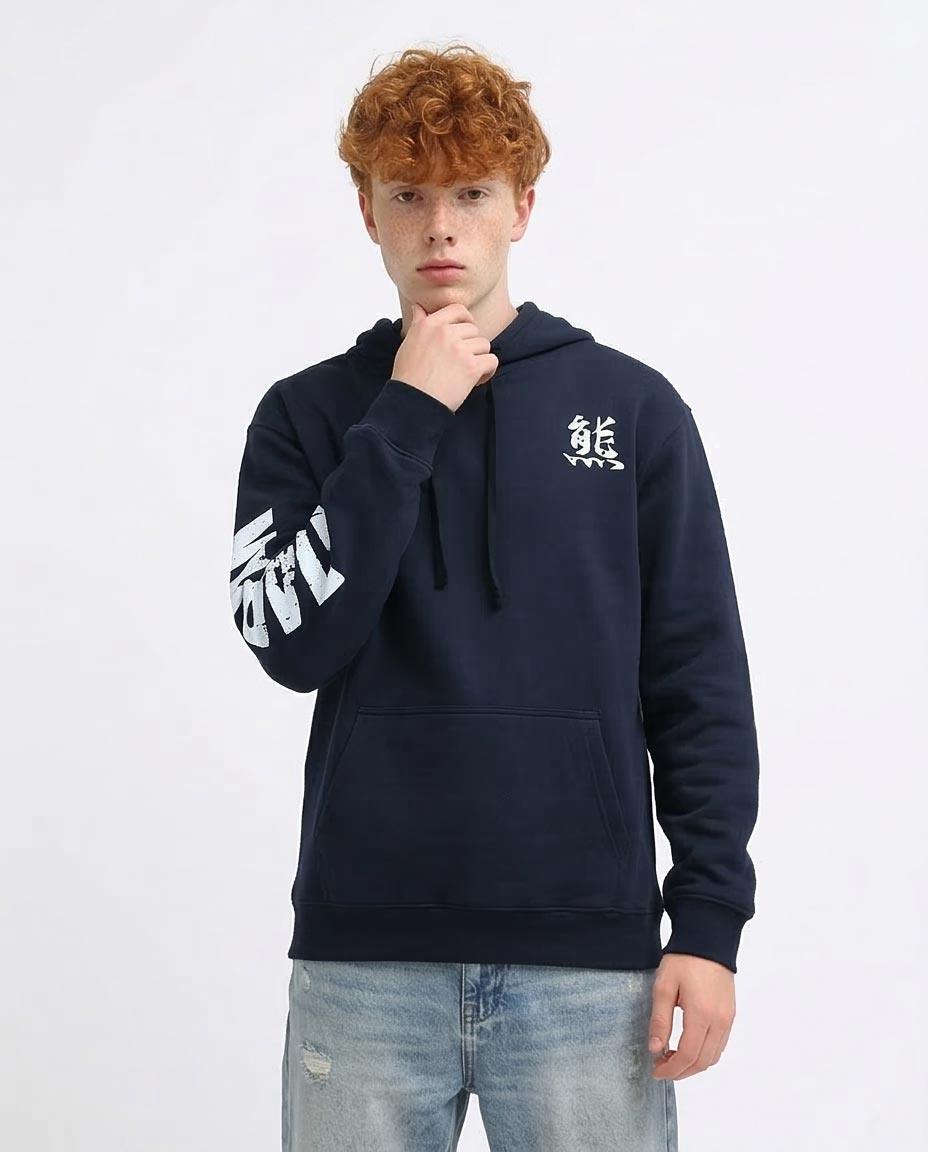 Person wearing a navy hoodie with a logo on a white background