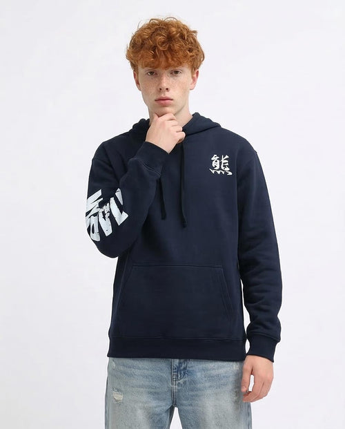 Person wearing a navy hoodie with a logo on a white background