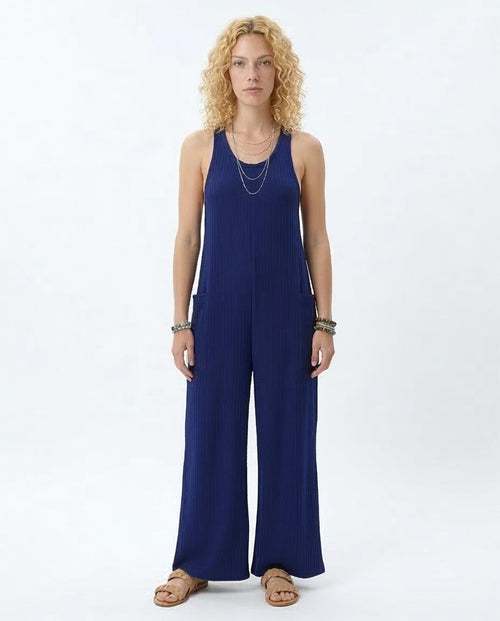 Woman wearing a blue jumpsuit on a white background