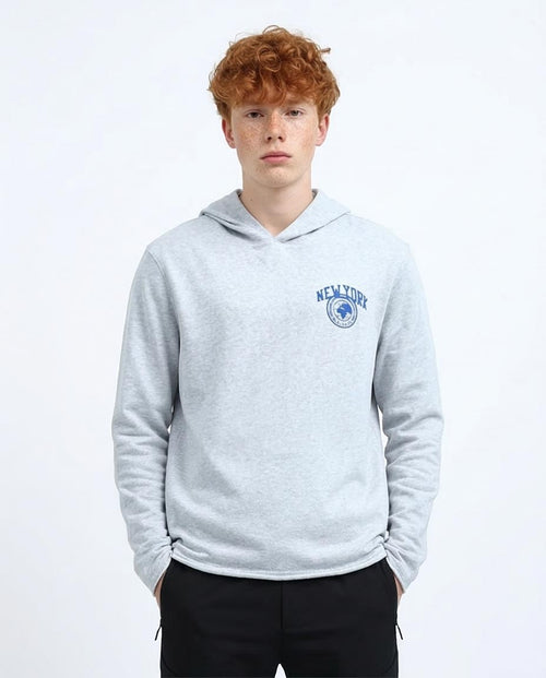 Person wearing a gray hoodie with 'New York' logo on a white background