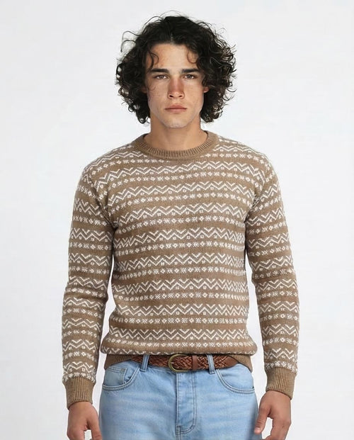 Man wearing a patterned sweater and jeans on a white background