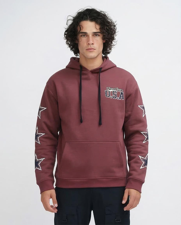 Man wearing a maroon hoodie with star designs and text on a white background