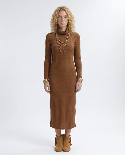 Woman wearing a brown ribbed dress with gold jewelry on a white background
