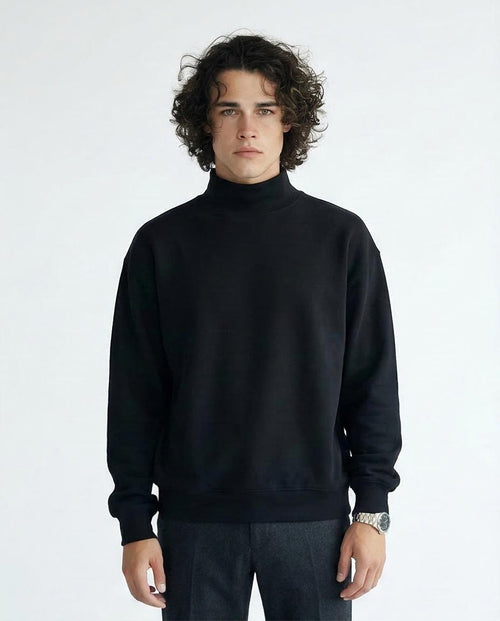 Man wearing a black turtleneck sweater against a white background