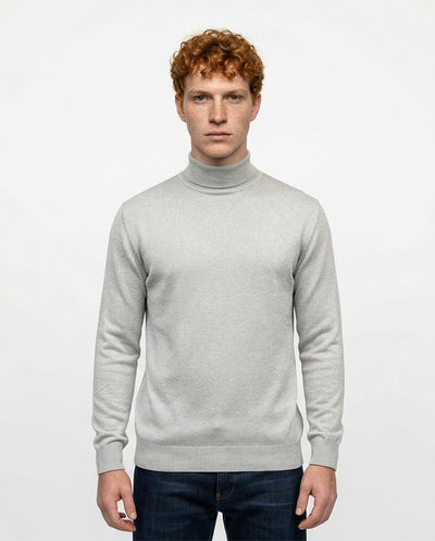 Man wearing a light gray turtleneck sweater on a white background