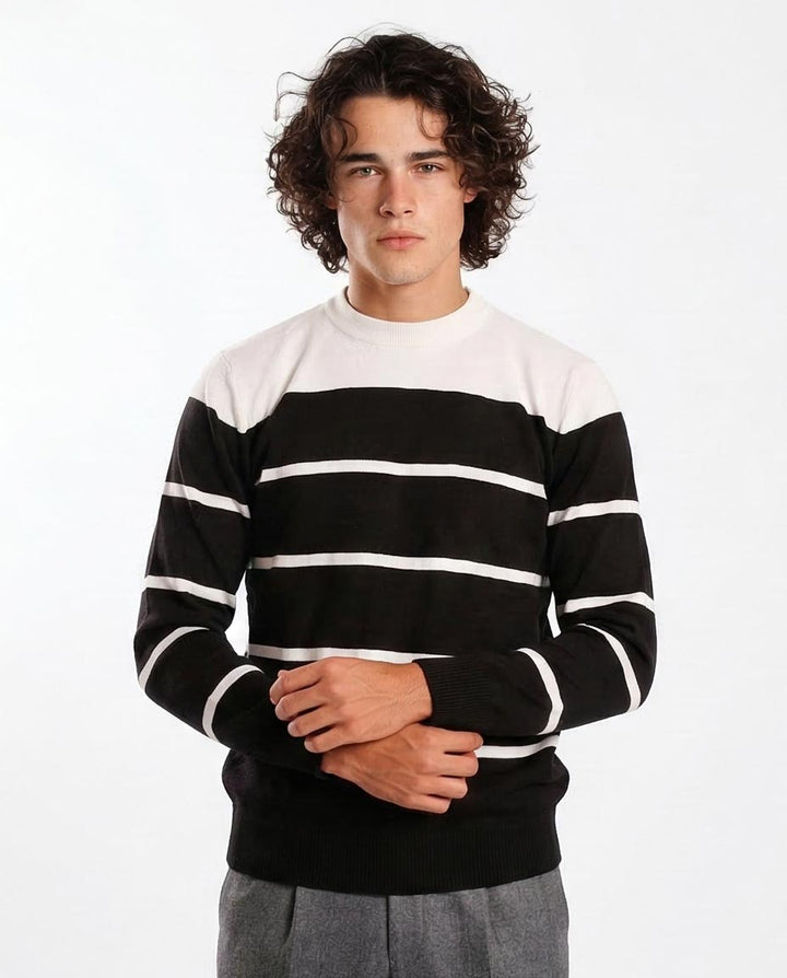 Person wearing a black and white striped sweater on a white background