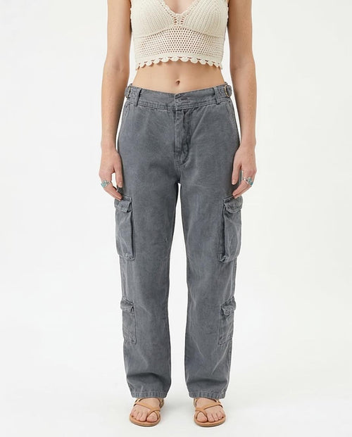 Woman wearing gray cargo pants on a white background