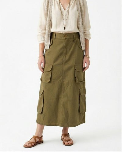 Person wearing a long olive green cargo skirt on a white background