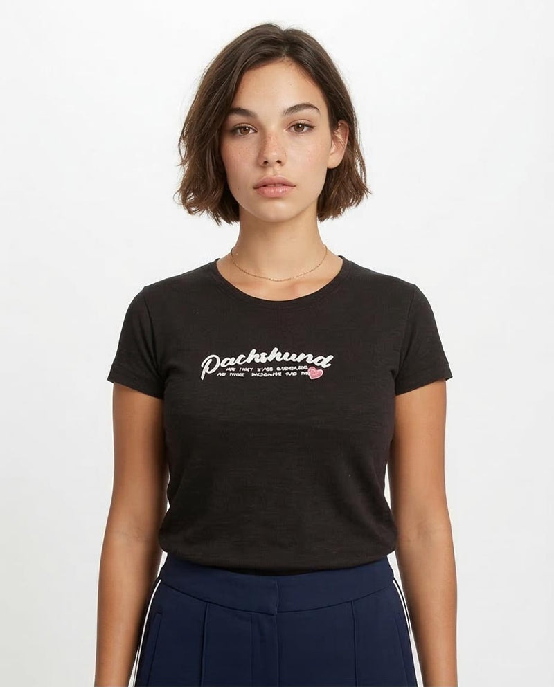 Person wearing a black t-shirt with 'Pachamama' text on a white background