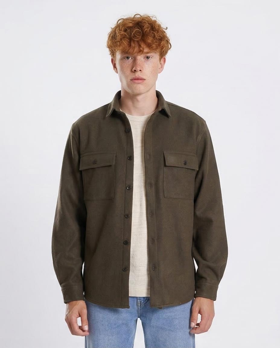 Man wearing a brown button-up shirt over a white t-shirt on a white background